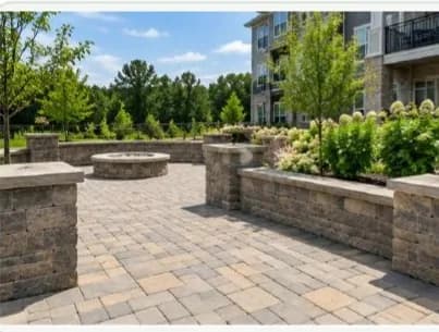 Paver walkway and retaining wall by a building entrance