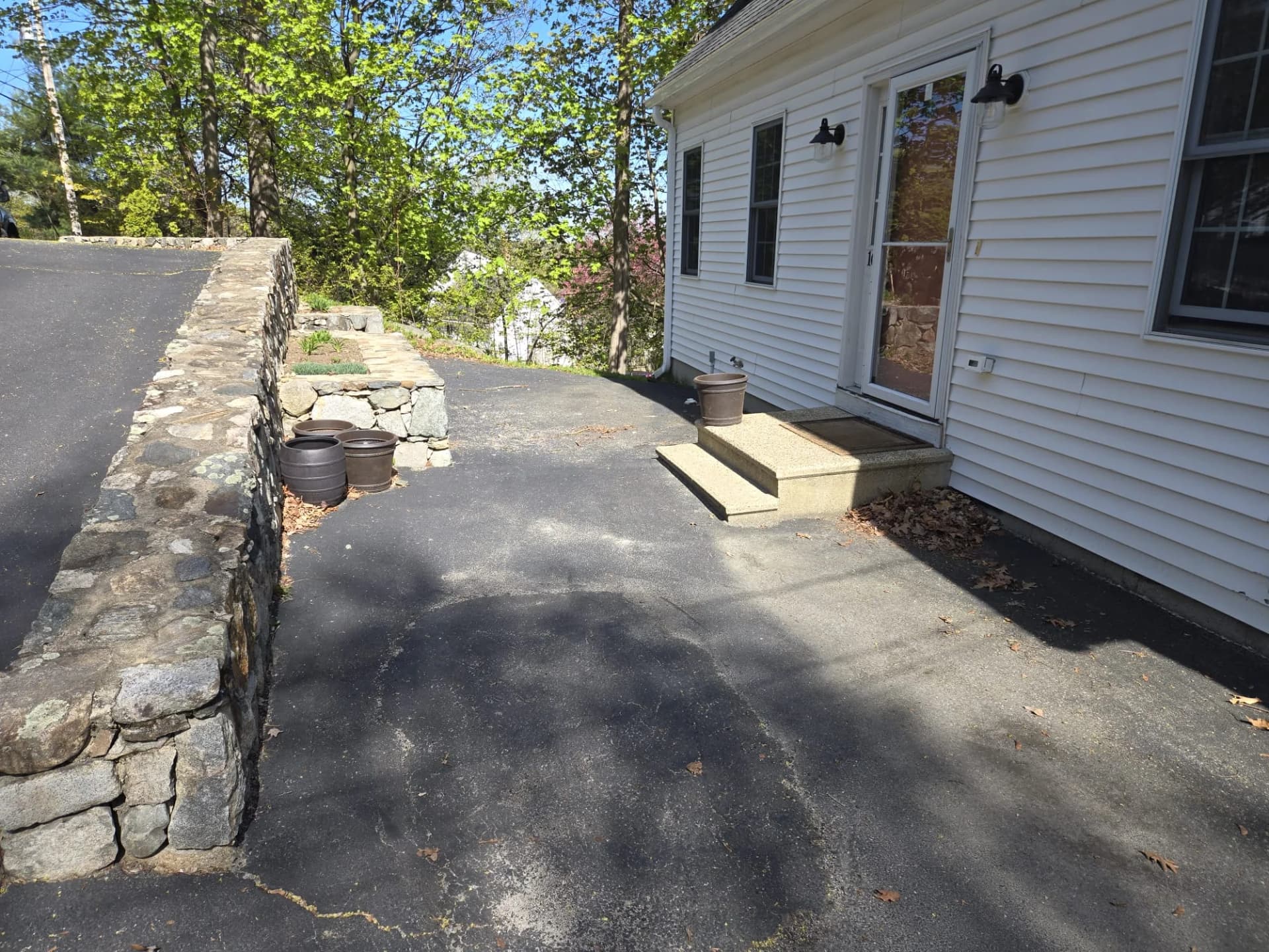 Asphalt surface beside the house before the patio work in Hudson, MA