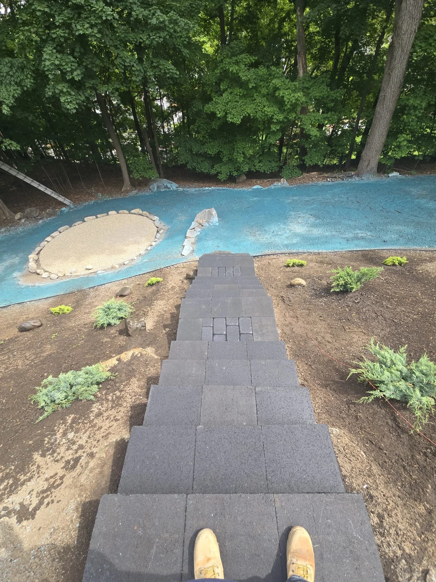 View from the outdoor steps toward the hydroseeded lower yard in Hudson, MA